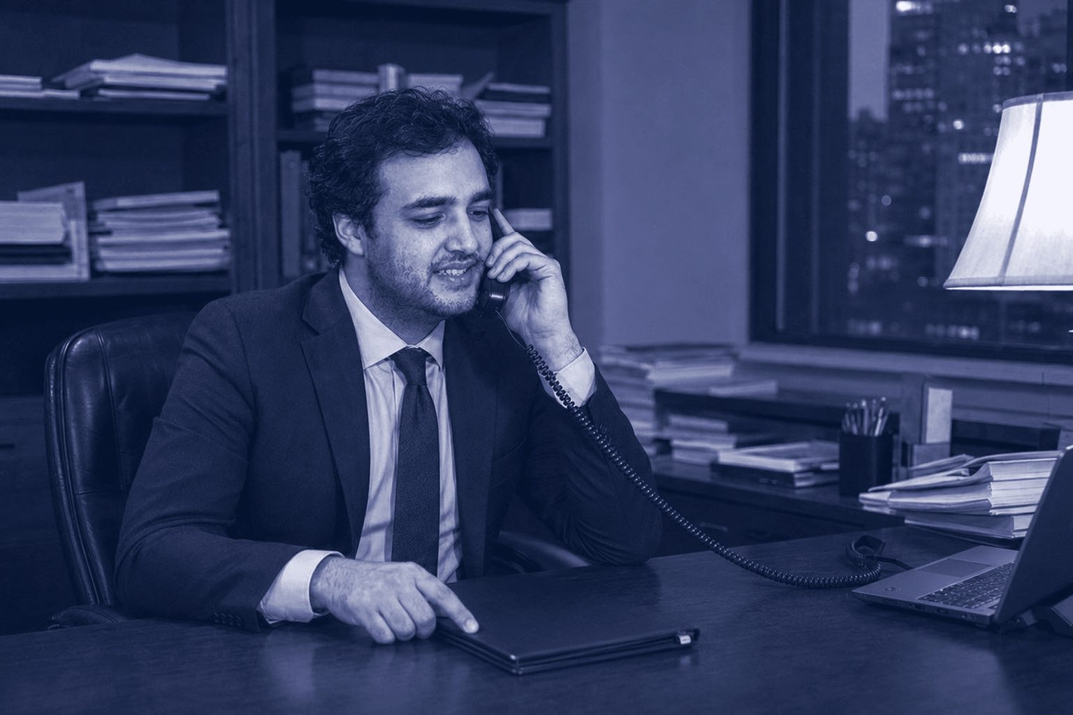 Mitchell Bromberg seated beside a client in a wheelchair, a notice of claim between them